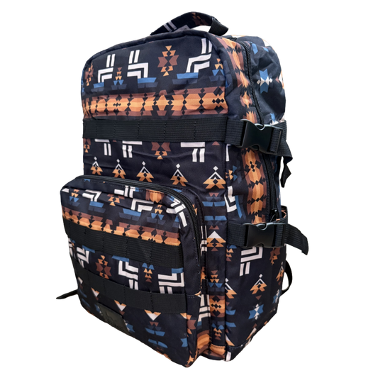 A backpack with a Southwestern geometric pattern in orange, white, and blue on a black background, shown against a plain white background.
