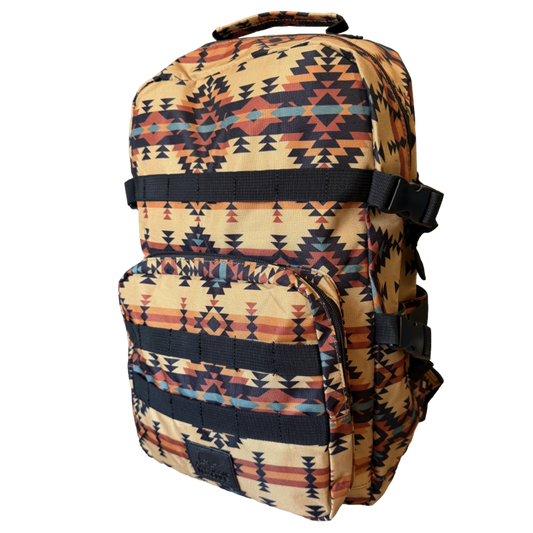 A backpack with a Southwestern geometric pattern in beige, black, orange, and blue, featuring a top carry handle and front utility pockets, shown against a plain white background.