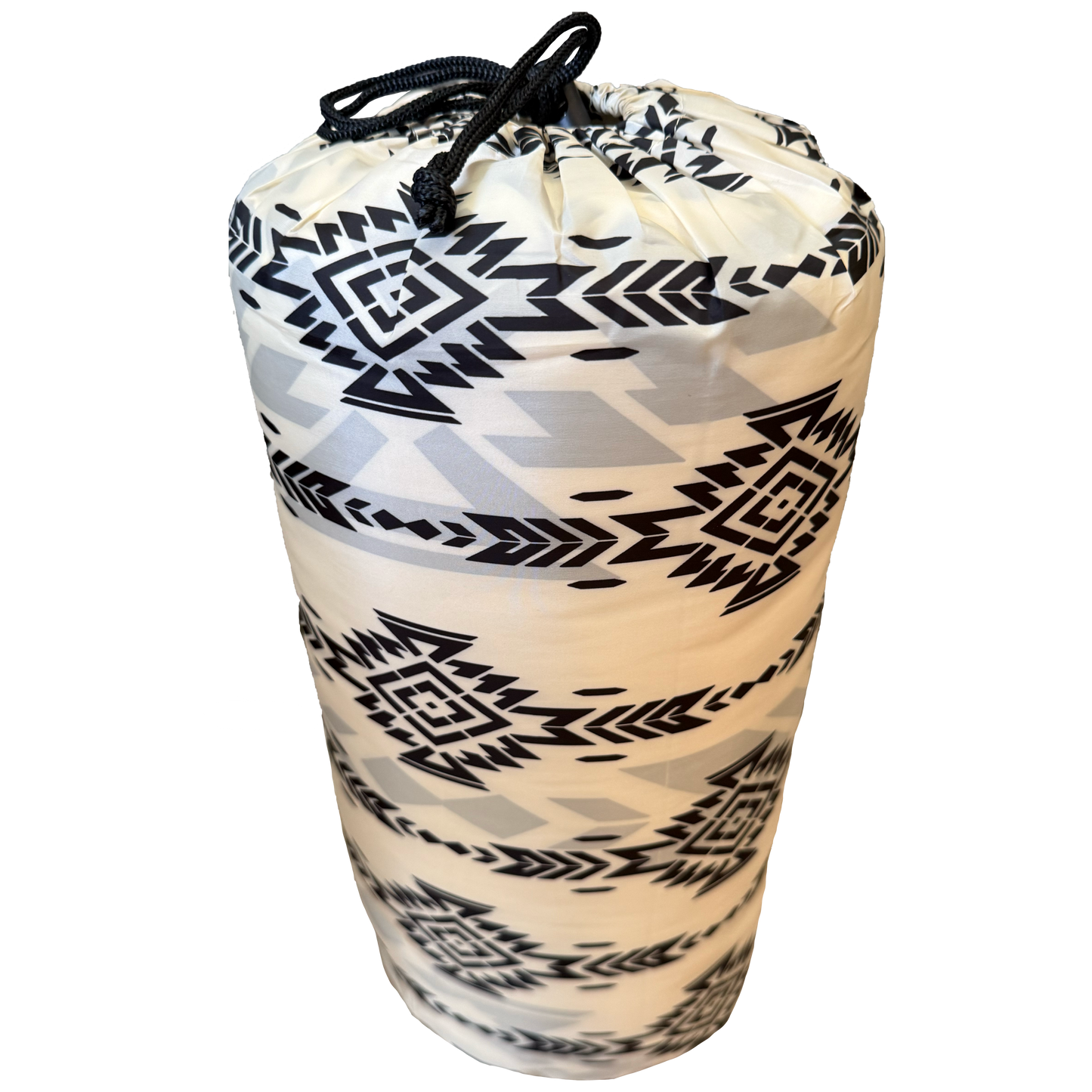 rolled-up poncho with black geometric pattern on a white background