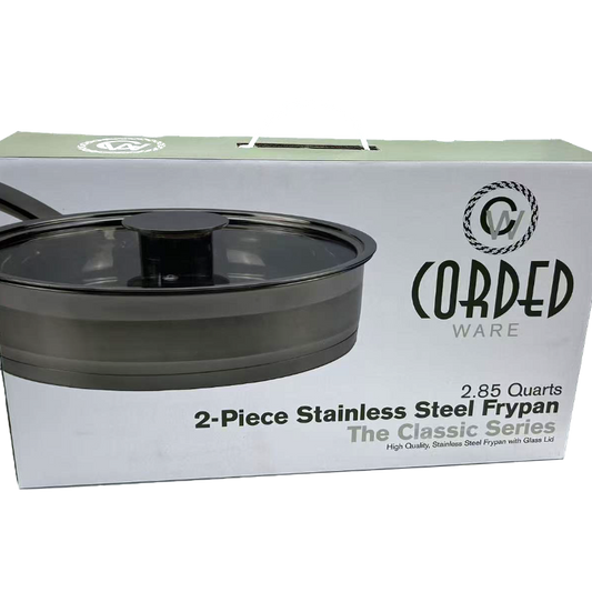 Box of Cored Ware 2-piece stainless steel frypan with lid on a white background