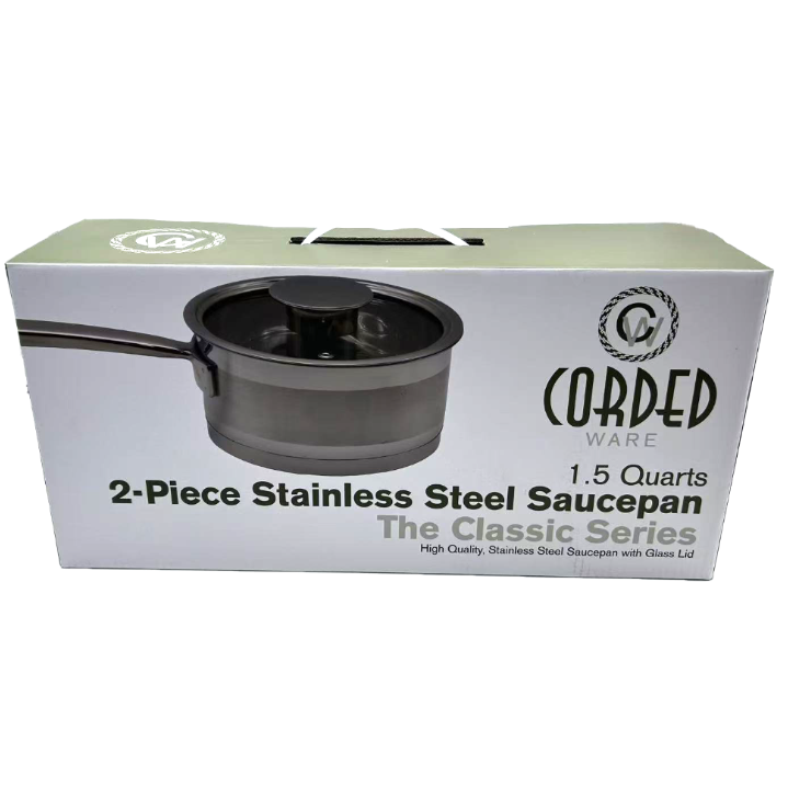 Box of Cored Ware 2-piece stainless steel saucepan with glass lid on a white background