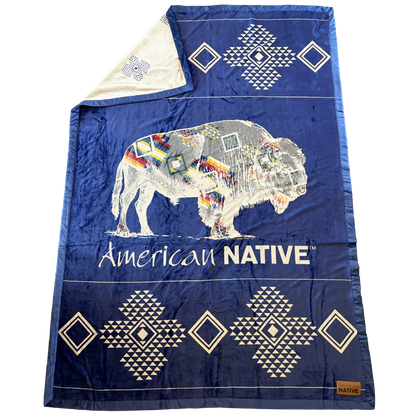 Blue blanket with a colorful bison design and 'American Native' text on a white background