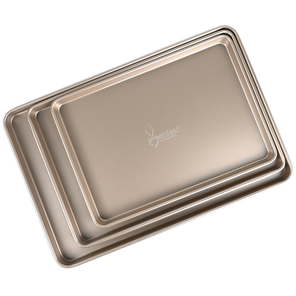 Set of three metallic baking trays with a brand logo on a white background