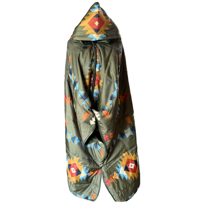 A hooded puffer poncho in olive green with a colorful geometric Southwestern pattern, shown against a plain white background.