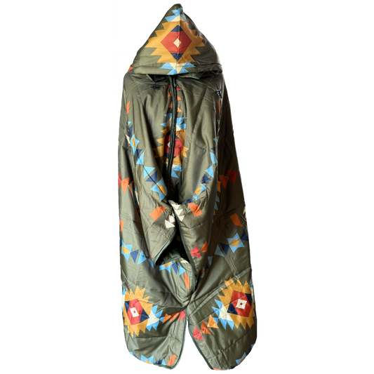 A hooded puffer poncho in olive green with a colorful geometric Southwestern pattern, shown against a plain white background.