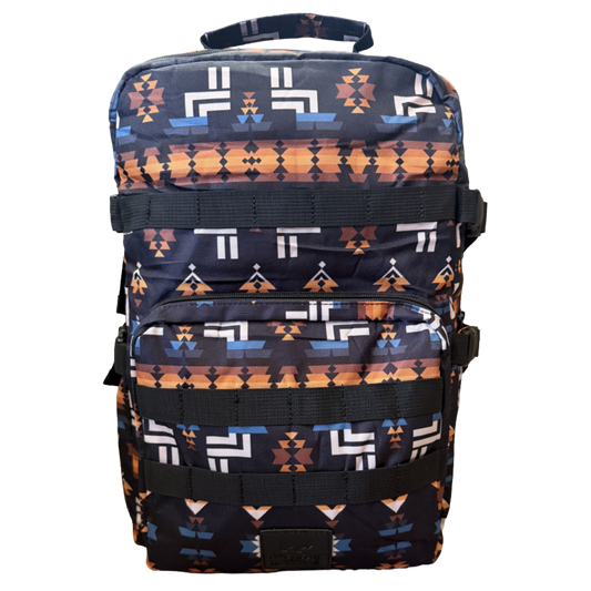 A backpack with a Southwestern geometric pattern in navy blue, orange, white, and brown, featuring black webbing straps and a top carry handle, shown against a plain white background.