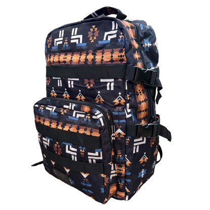 A backpack with a Southwestern geometric pattern in orange, white, and blue on a black background, shown against a plain white background.