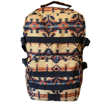 A backpack with a Southwestern geometric pattern in beige, black, orange, and blue, featuring a top carry handle and front utility pockets, shown against a plain white background.