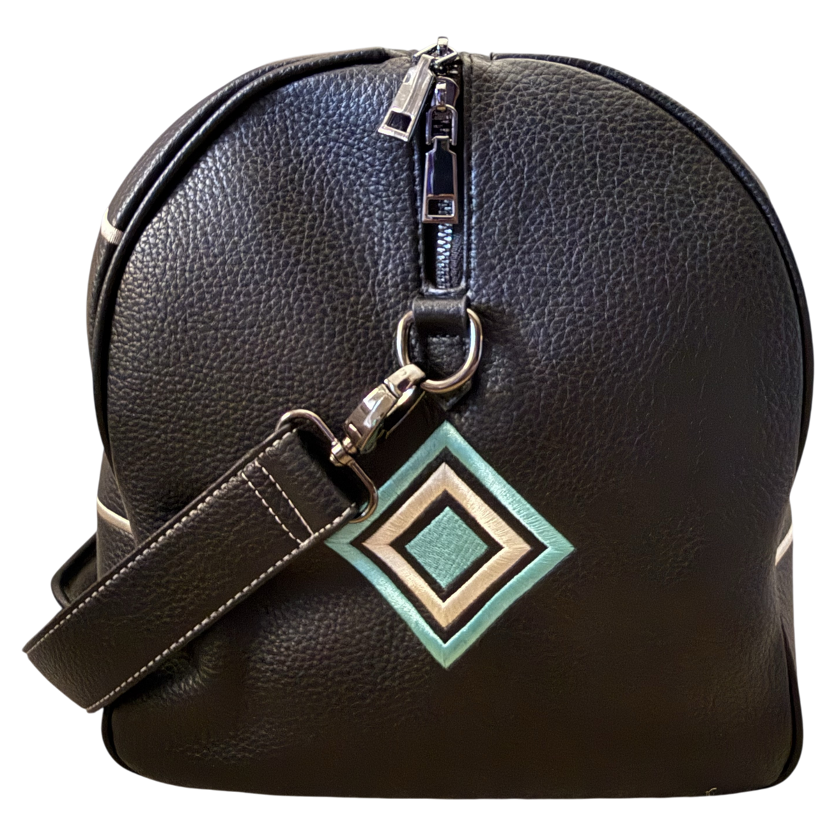 A black pebbled leather duffel bag with a silver zipper, a matching shoulder strap, and a geometric diamond-shaped metal charm in green, beige, and white, shown against a plain white background.