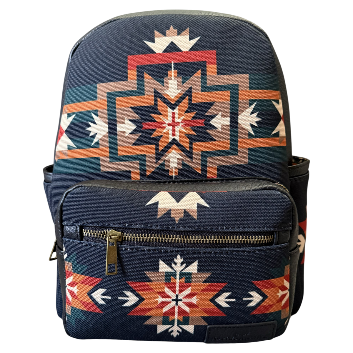 A navy blue backpack featuring a Southwestern geometric pattern in orange, beige, and white, with a front zippered pocket.