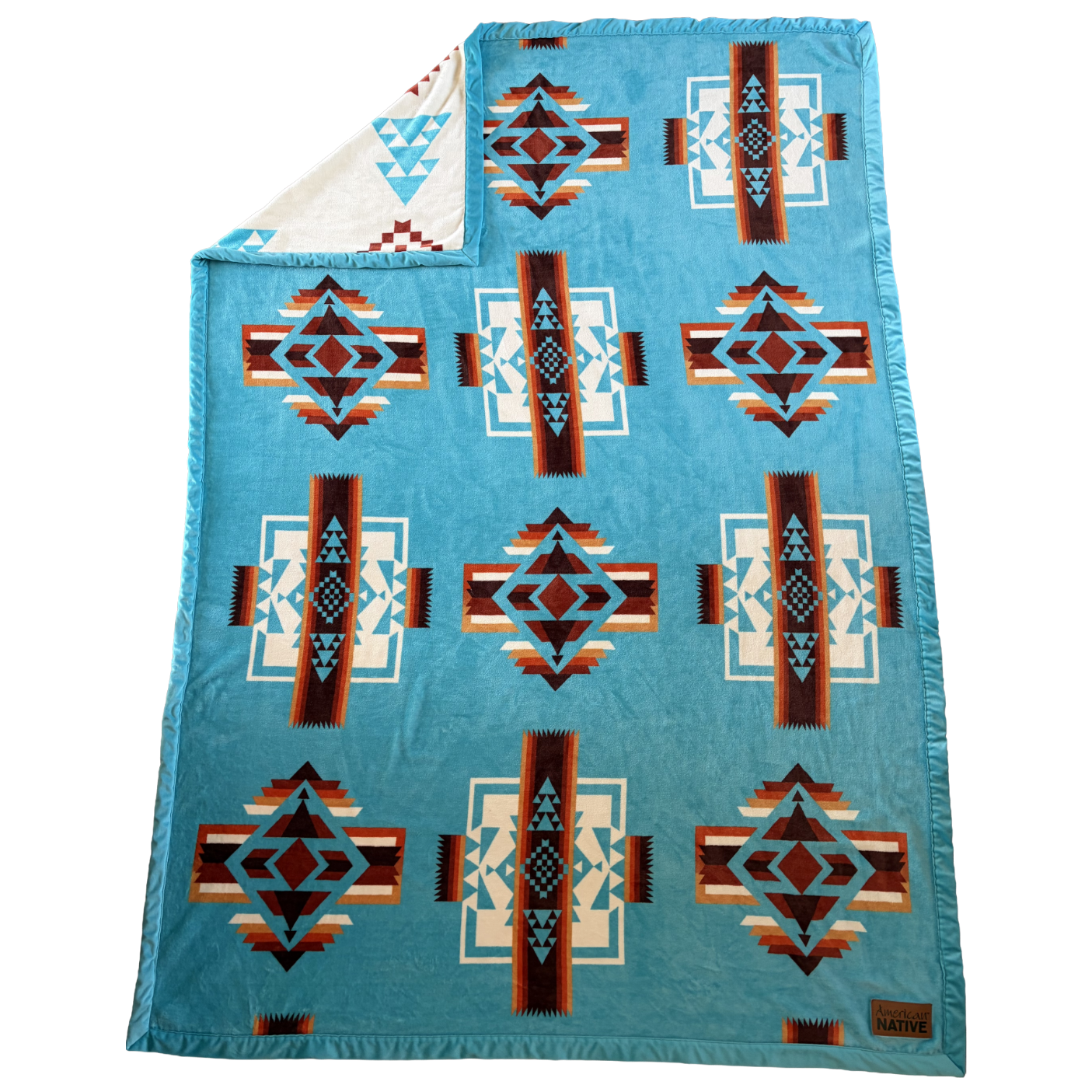 Blue patterned blanket with geometric designs on a white background