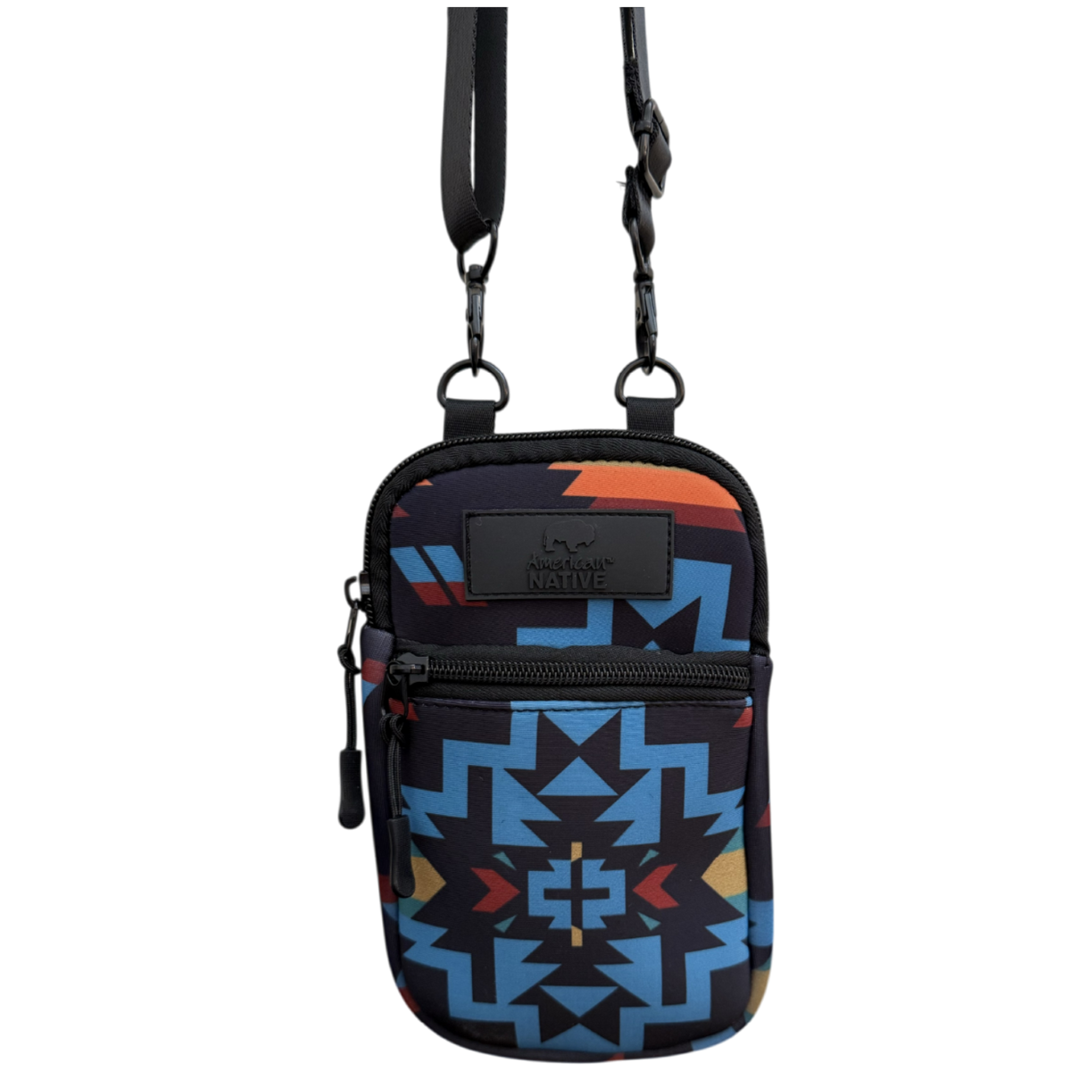 A small crossbody phone bag with a black strap and a Southwestern geometric pattern in blue, orange, and red on a black background, shown against a plain white background.