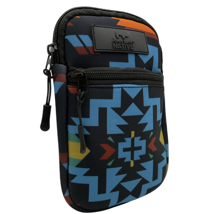 A small Native American-themed pouch with a Southwestern geometric pattern in blue, black, orange, yellow, and red, featuring a black leather brand patch.
