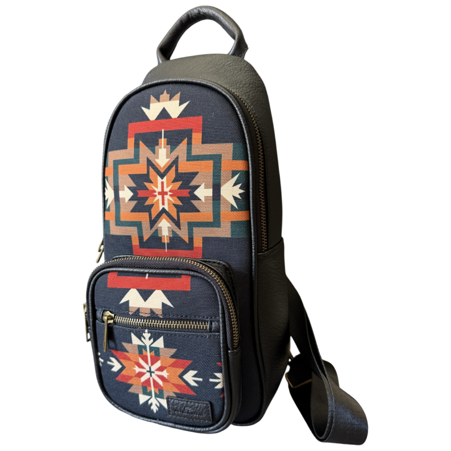 A small black shoulder bag with a Southwestern geometric pattern in red, orange, beige, and white, featuring a top handle and a detachable shoulder strap, shown on a plain white background.