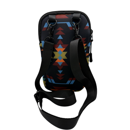 A black crossbody phone bag with a colorful geometric Southwestern-style pattern in blue, red, and yellow, featuring an adjustable black strap and black hardware, shown on a plain white background.