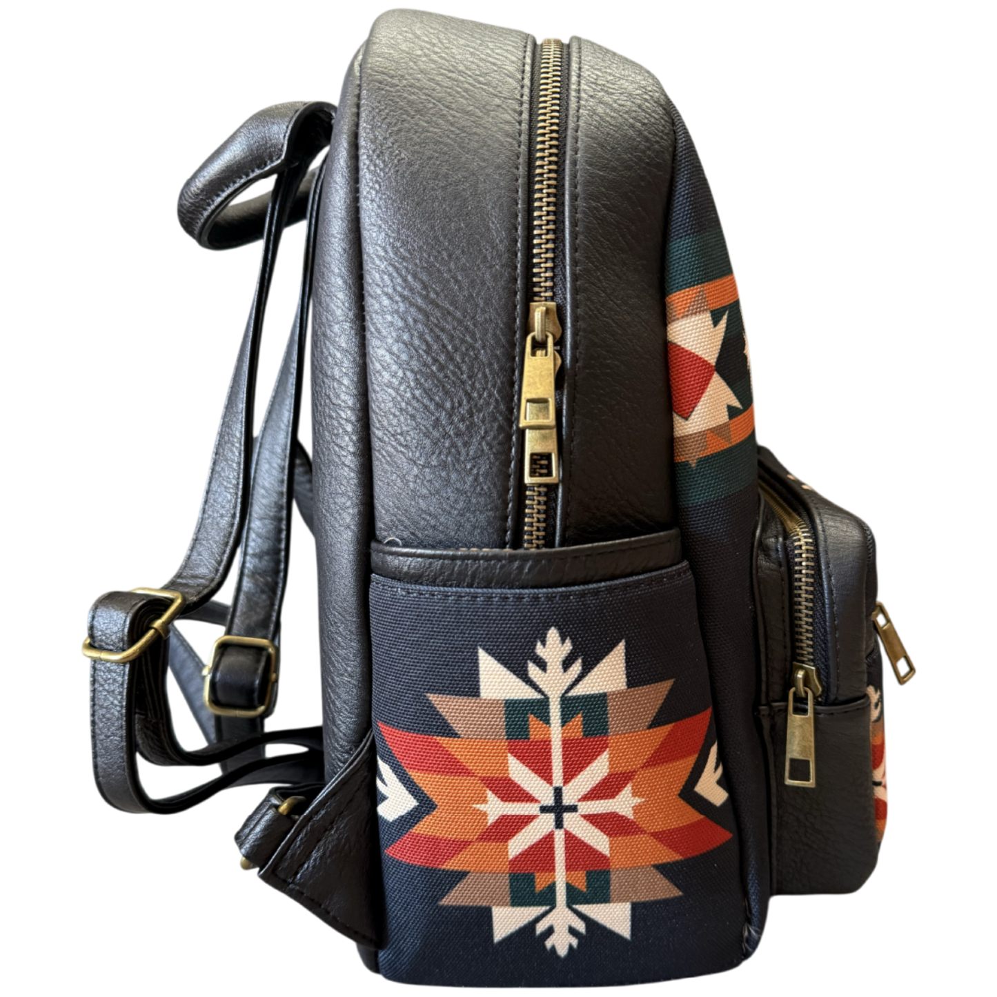 Black faux leather backpack with gold zippers and a Southwestern geometric pattern on the front pocket, shown against a plain white background.
