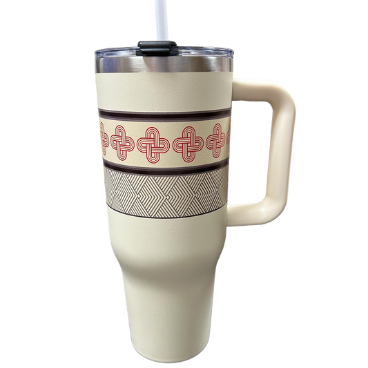 White travel mug with red and black geometric pattern on a white background
