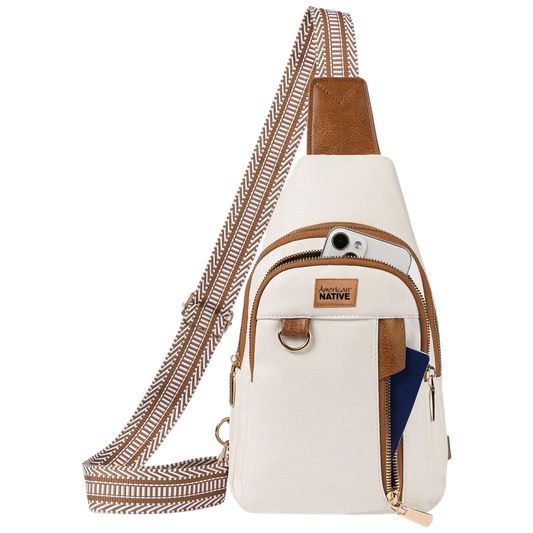 White crossbody bag with brown accents and a patterned strap on a white background