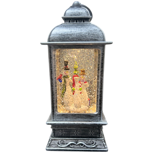 Decorative lantern with snowman and gingerbread man inside on a white background