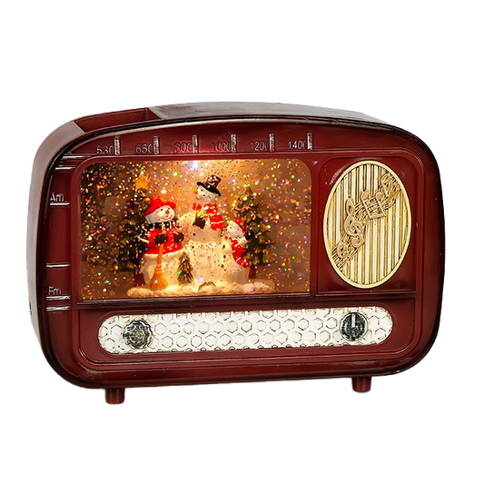 Vintage-style radio with snowman and Christmas tree display on a white background
