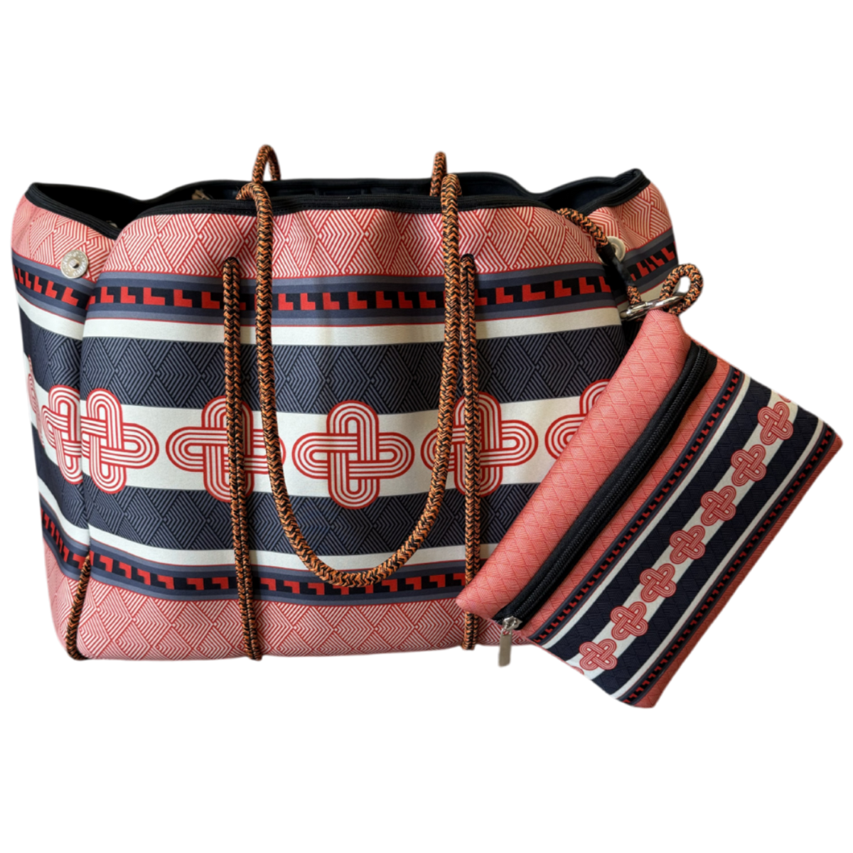 A red and black patterned tote bag with a matching zippered pouch, featuring geometric and Celtic knot designs, brown woven handles, and gold-tone hardware, shown on a plain white background.