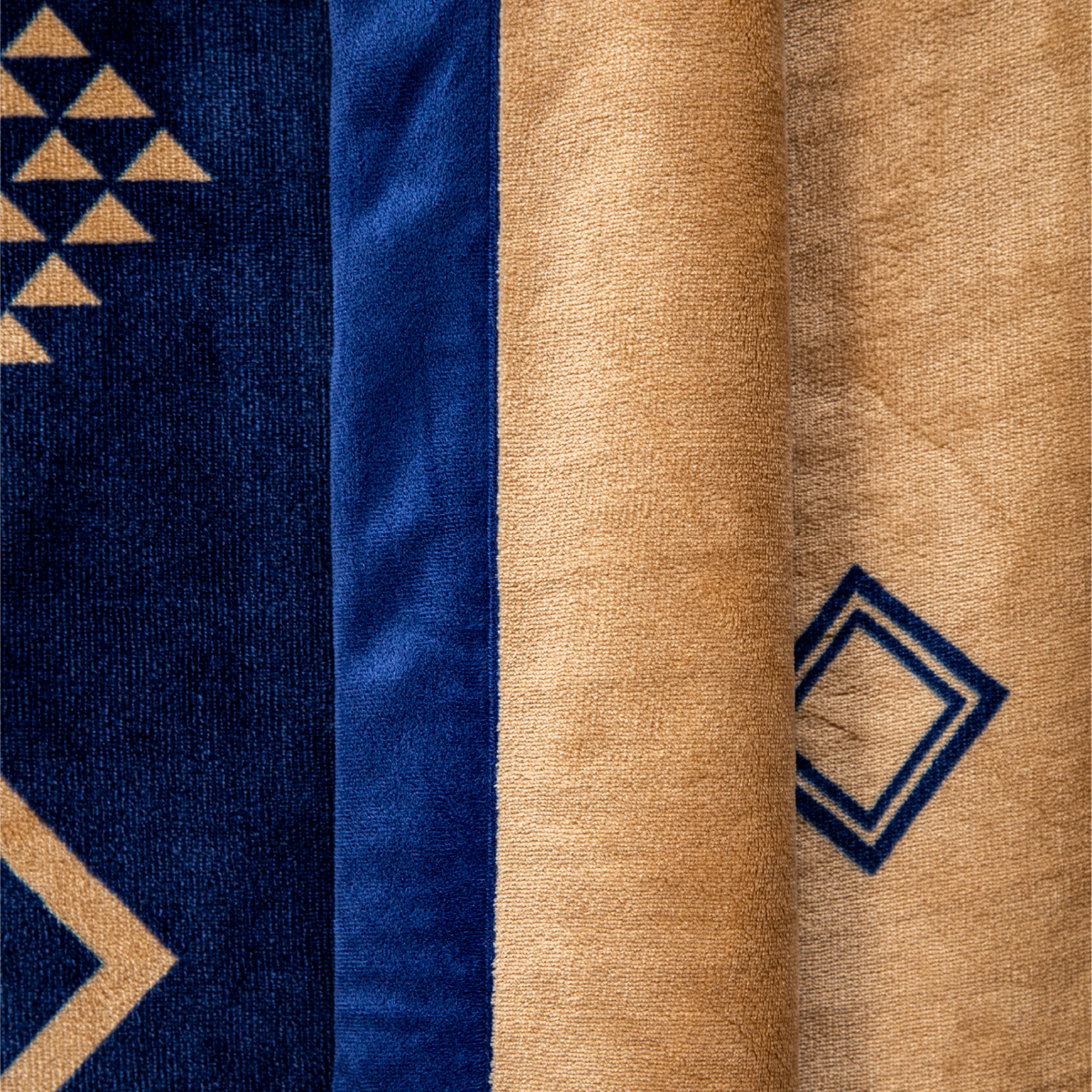 Close-up of fabric with geometric patterns in blue and beige.