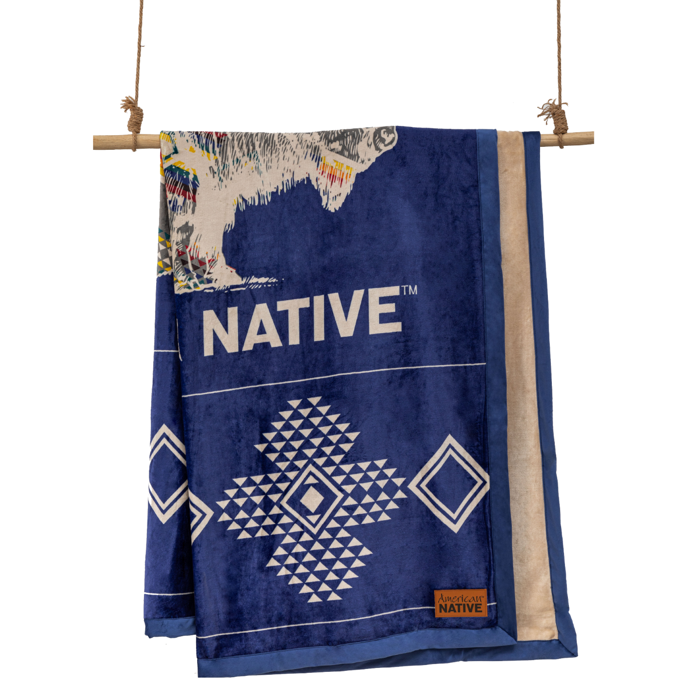 Navy and cream reversible blanket with geometric and buffalo patterns  on a wooden rod.