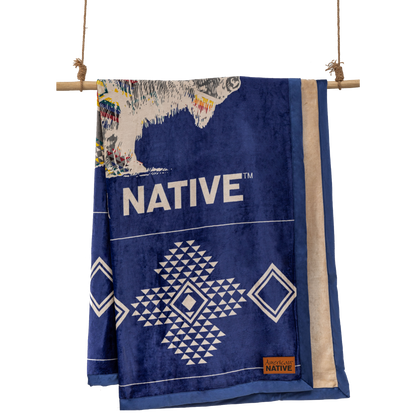 Navy and cream reversible blanket with geometric and buffalo patterns  on a wooden rod.