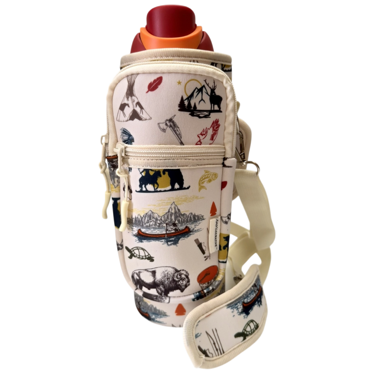 A cream-colored insulated bottle bag with a colorful outdoor-themed print of bison, mountains, and a canoe. The bag features a front zippered pocket and a matching shoulder strap, shown holding a bottle with a red cap against a plain white background.