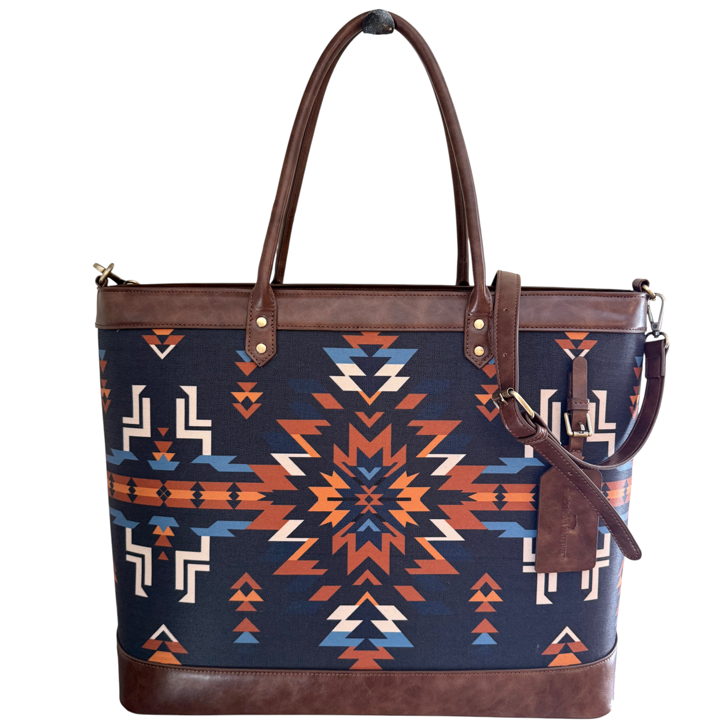 Tote bag with geometric pattern and brown leather accents on a white background